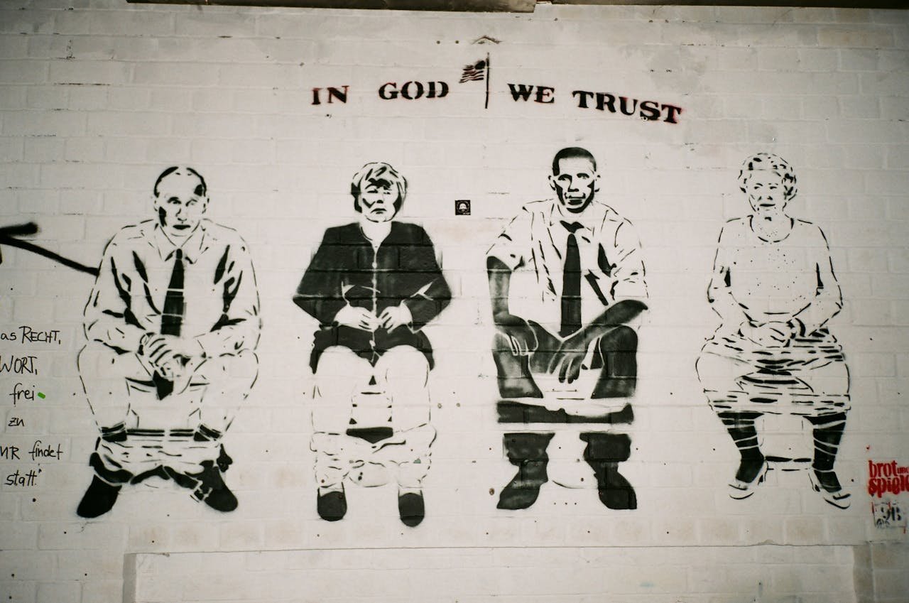 Satirical street art mural depicting political figures on a brick wall.