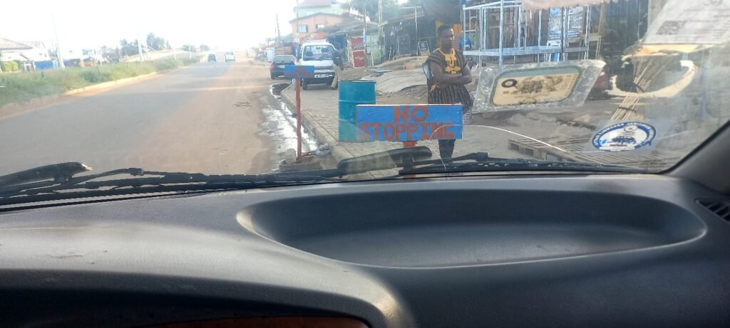 Car packed at no stopping signage Ghana indiscipline monetisation 
