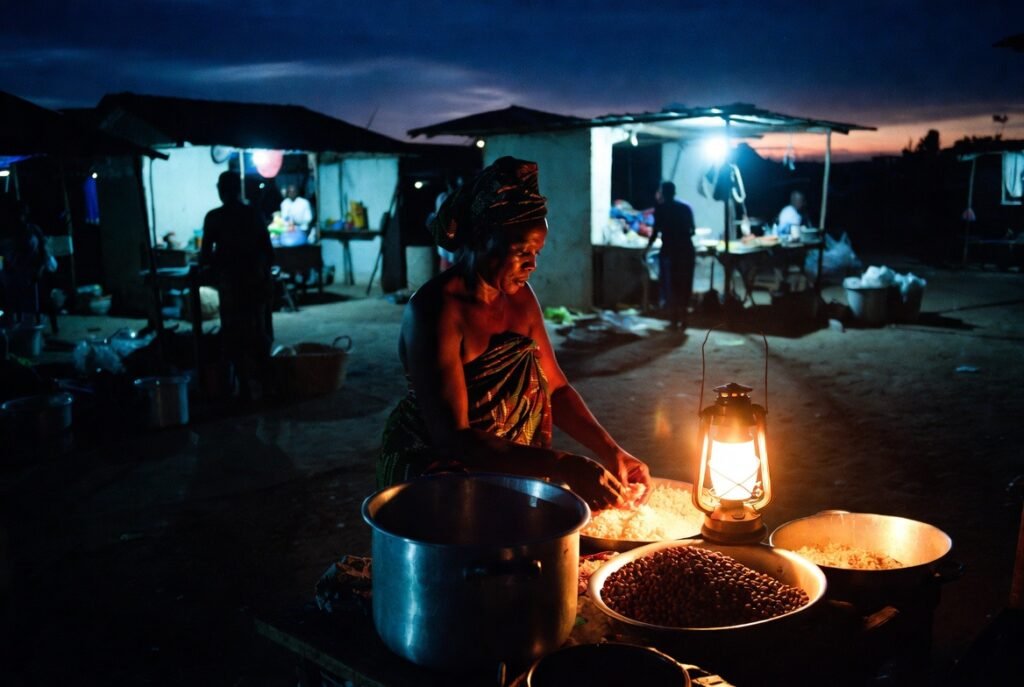  Ghanaian market woman waakye stall pre-dawn Accra informal economy 24 hours