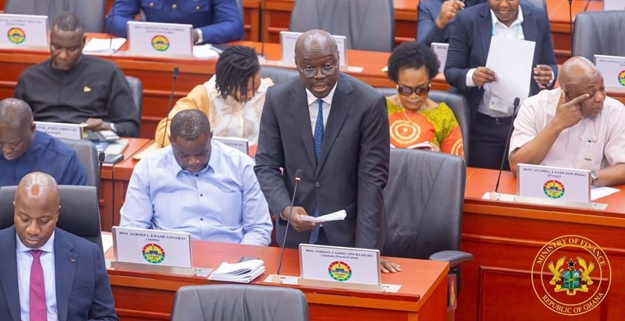 Ghana Value for Money Office satire — Legal Division lawyers stand at pool edge as new government pond is constructed nearby